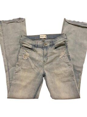 Light wash distressed flare jeans with frayed hems and ripped knees